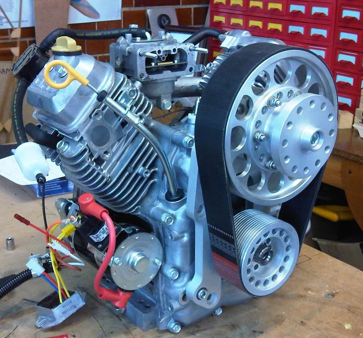 A Briggs & Stratton V-twin engine fitted with an Ace Aviation belt-drive reduction unit on a workbench